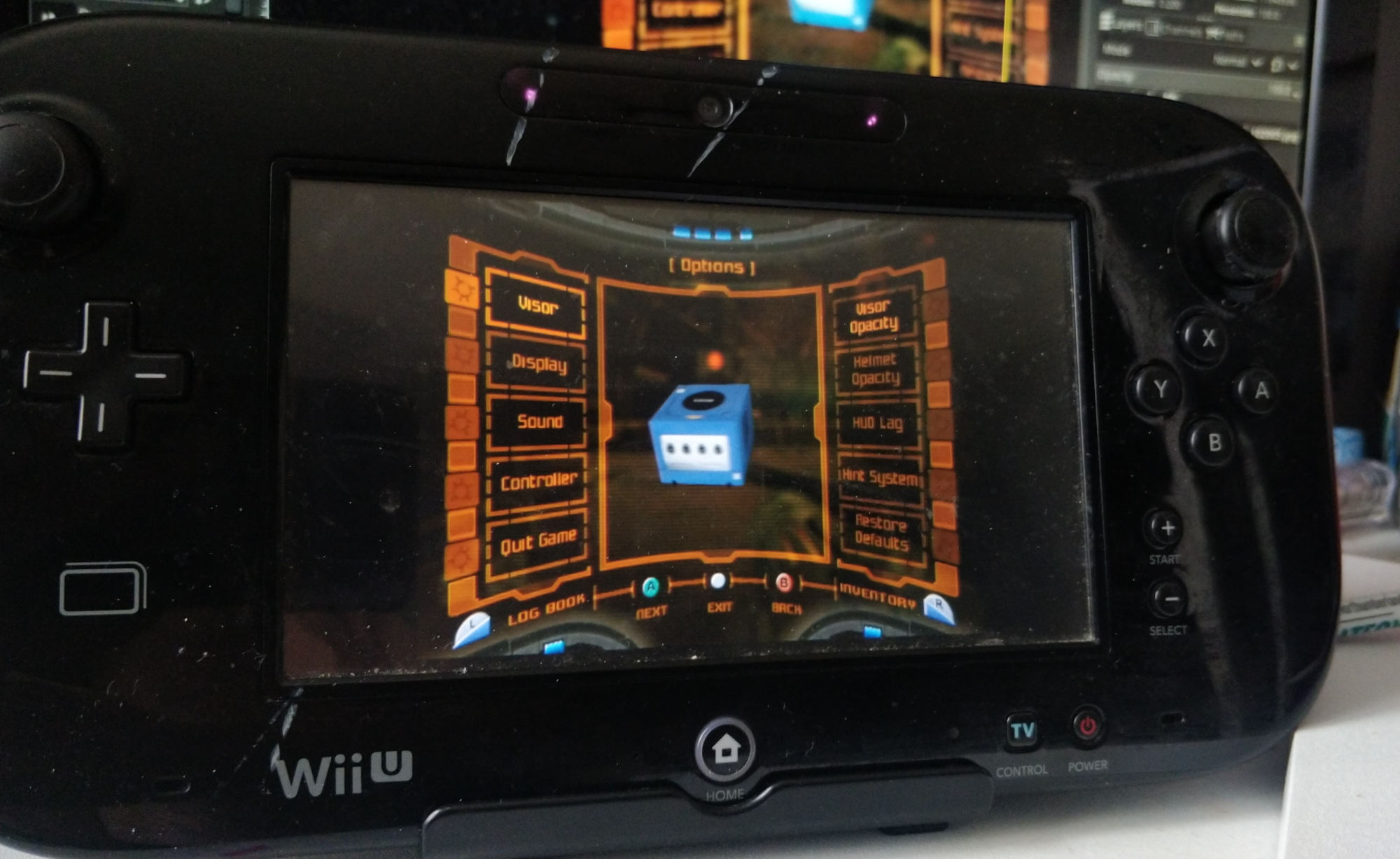 wii u gamepad controller with metroid prime pause menu displayed, which has a gamecube model.
