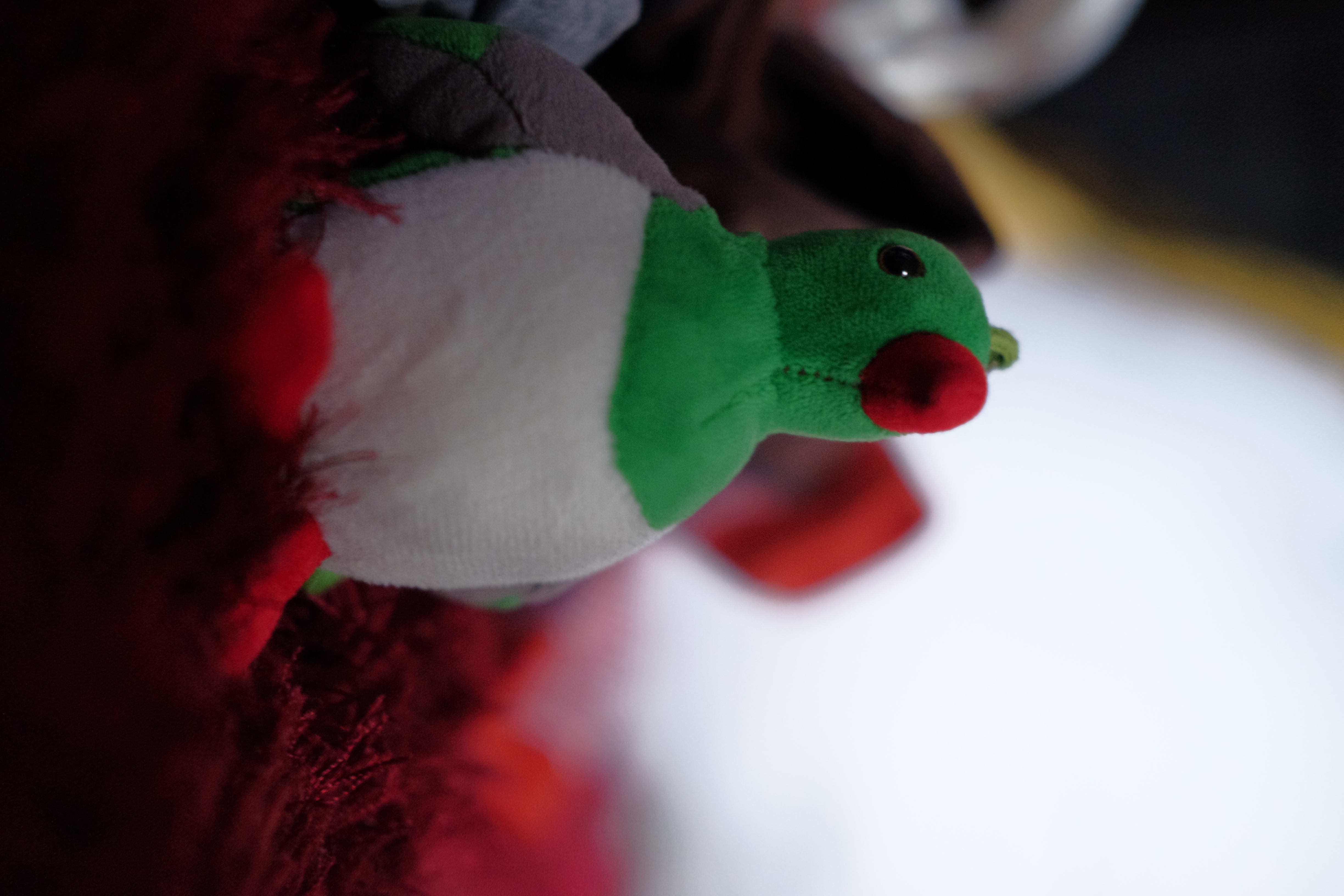photo of a plump and round green pigeon plushie
