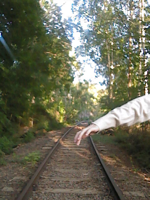 low res image of a rail track with a head balancing in frame.