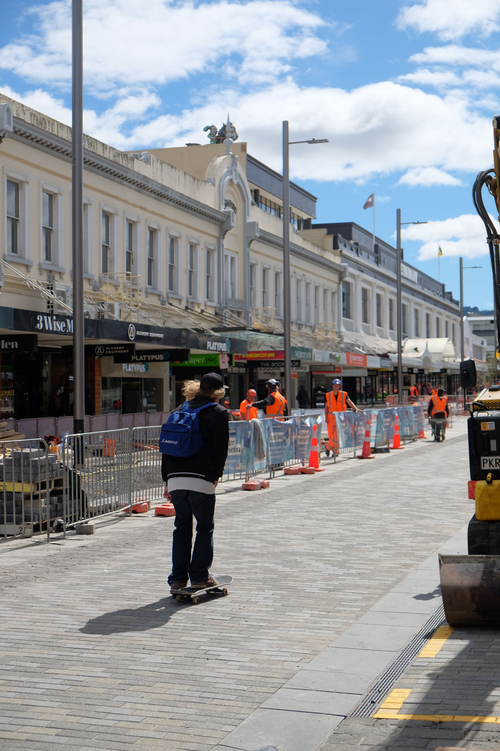 the same street but with some partitioned off behind construction barriers.