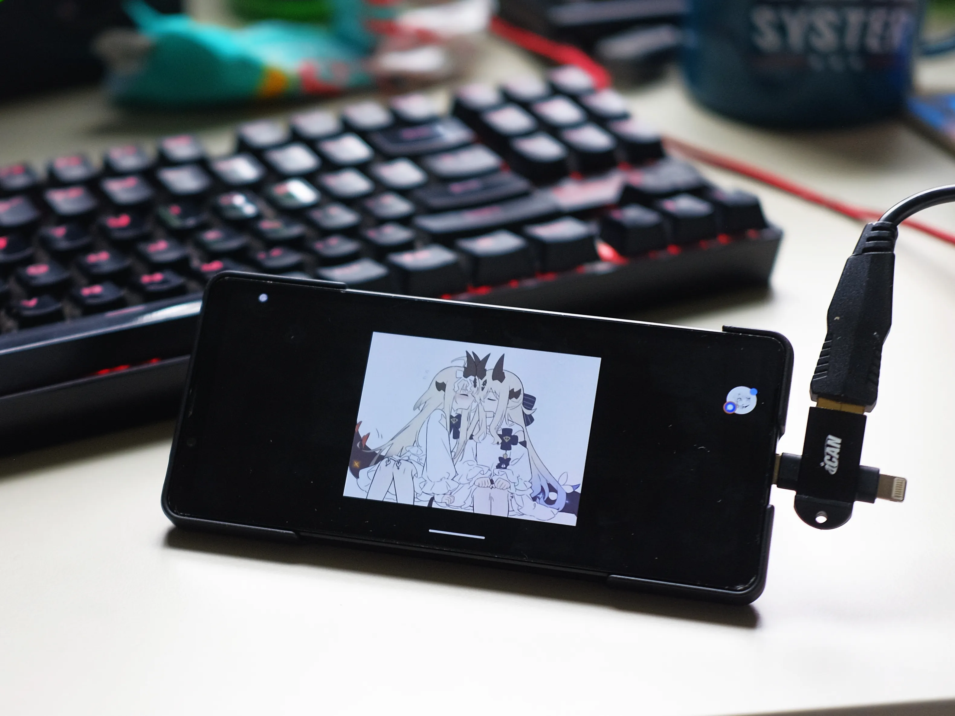 girls kissing on the screen with a ican addapter plugged in