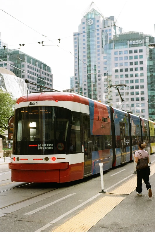 grainy film photo of the back of a tram in downtown toronto.